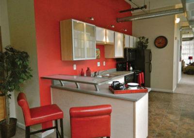 Kitchen with red walls 和 椅子 at 圣克莱尔阁楼 apartments for rent in Dayton, OH